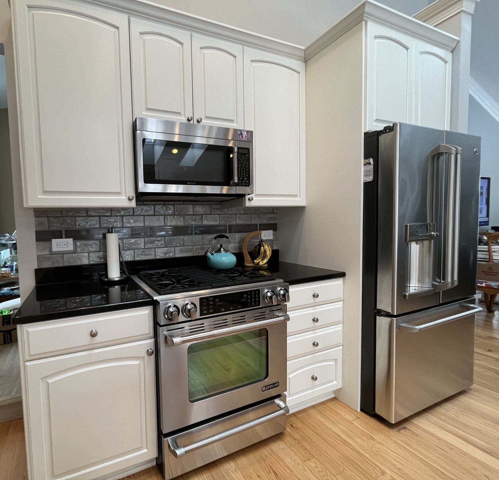 Refinished white kitchen cabinets near stove