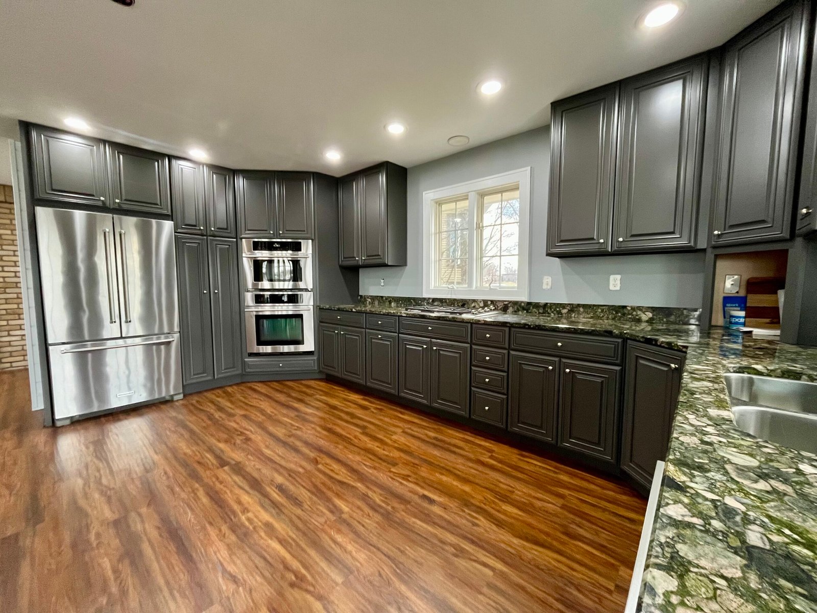 Hardwood kitchen cabinets refinished in gray by Craine Painting in Lake Geneva.