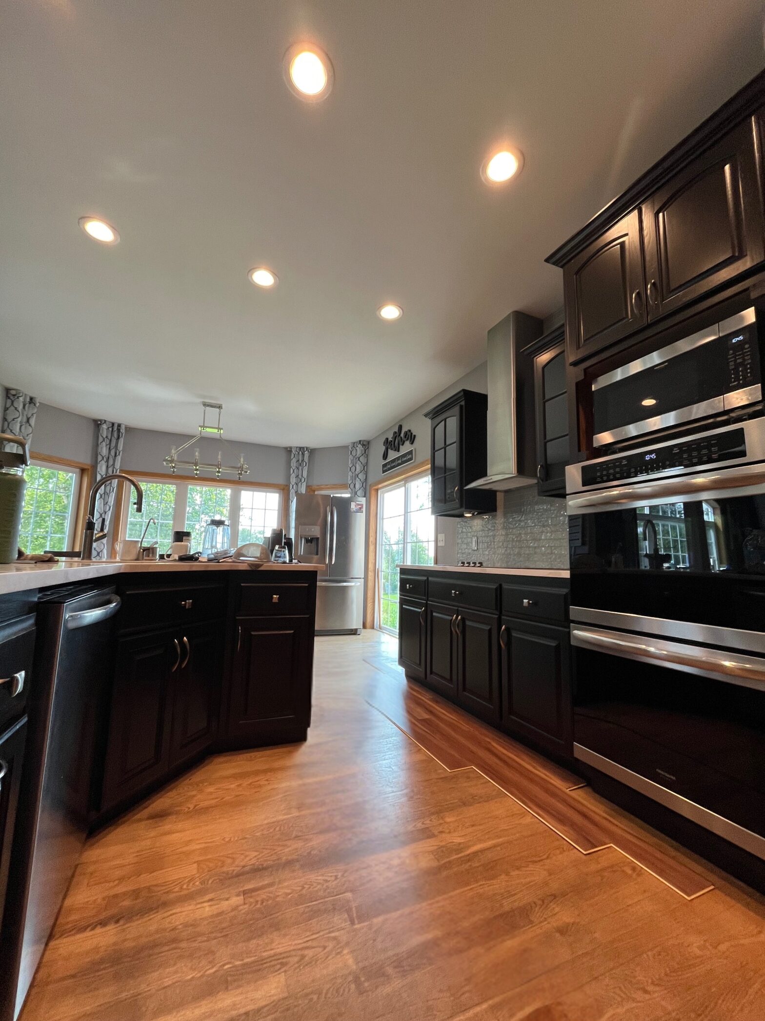 Refinished kitchen in Muskego, WI. Cabinets finished in deep brown stain.