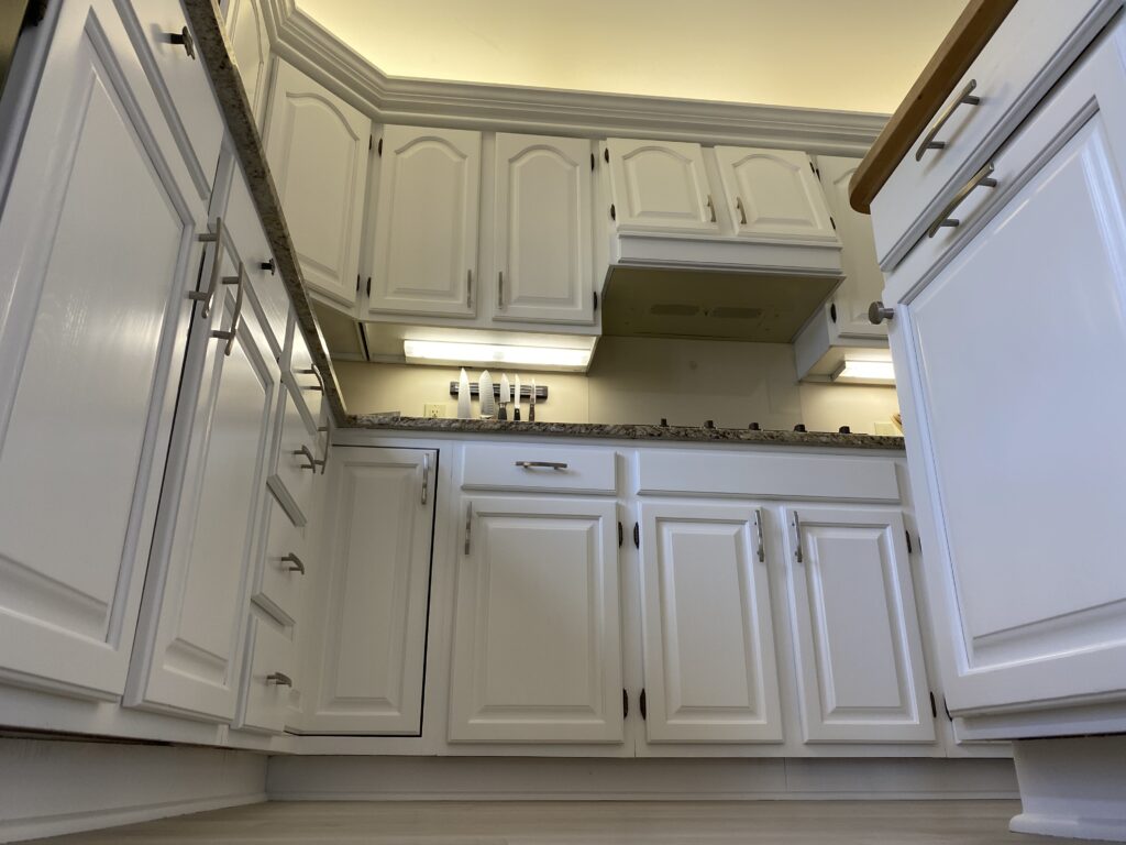 Refinished kitchen cabinets in white