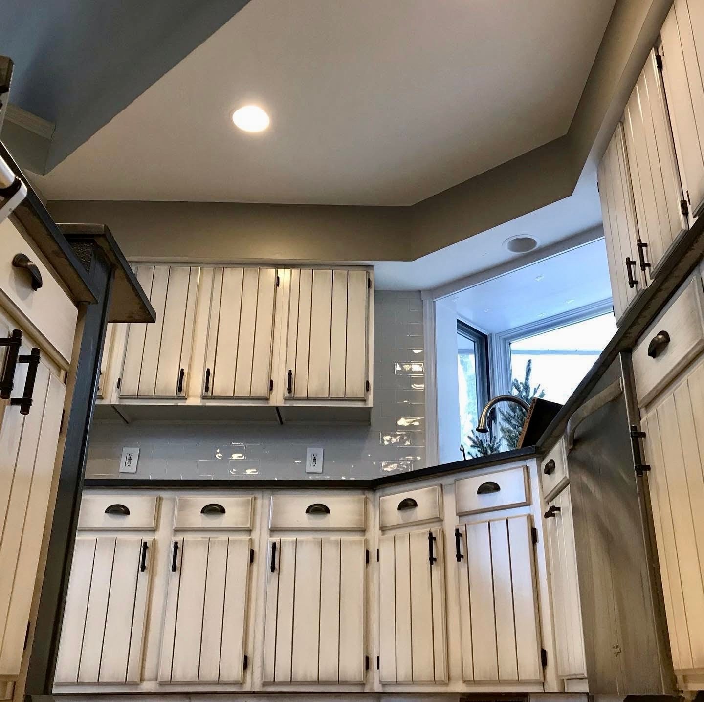 Refinished and glazed white kitchen cabinet doors.